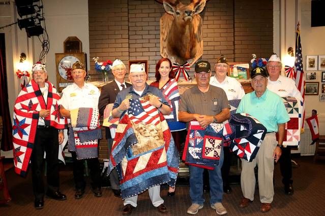 (Left to Right) Adjutant Gary Lowe, Chaplain Ken Wilson, Comrade Frank Sobotka, Quartermaster Bob Penney, Comrade Rachael Watters, Comrade William Taylor, Post Commander Ralph Groover, Comrade Mike Hanson and Jr Vice Commander Hugh Crawford with their “Quilts of Valor”
